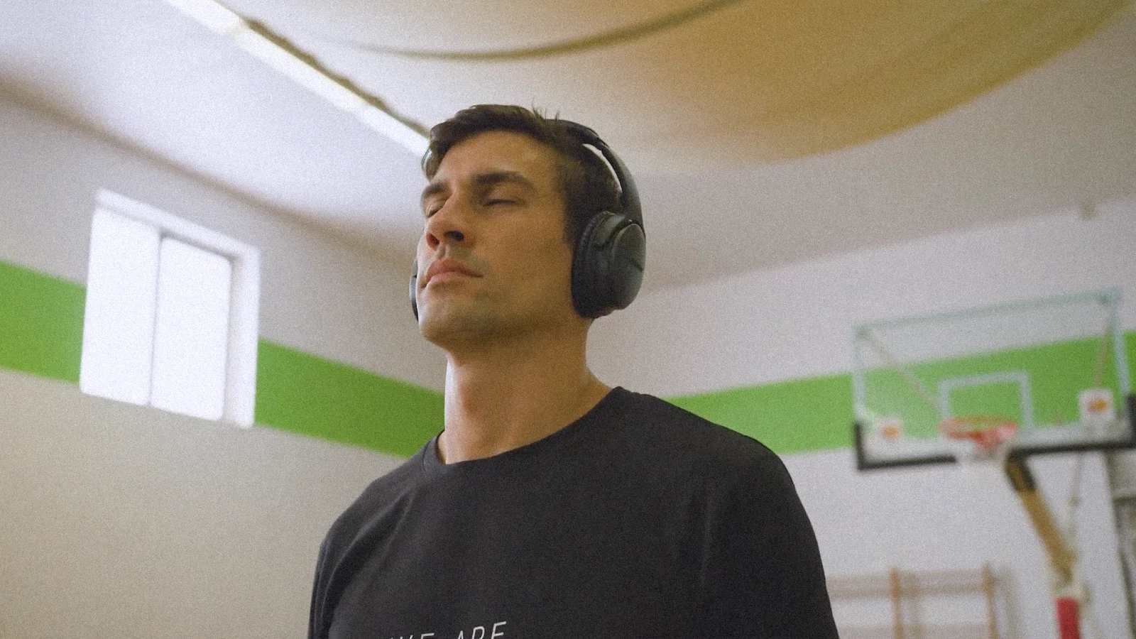 guy wearing headphones in basketball court