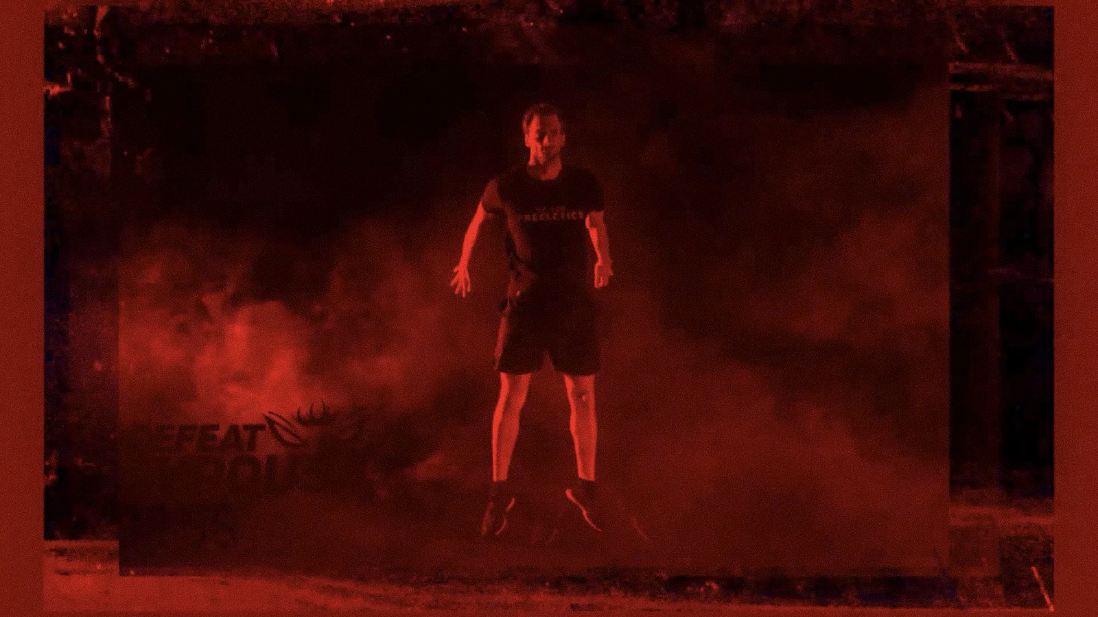 Athlete jumps in dramatic red smoke while wearing Freeletics gear
